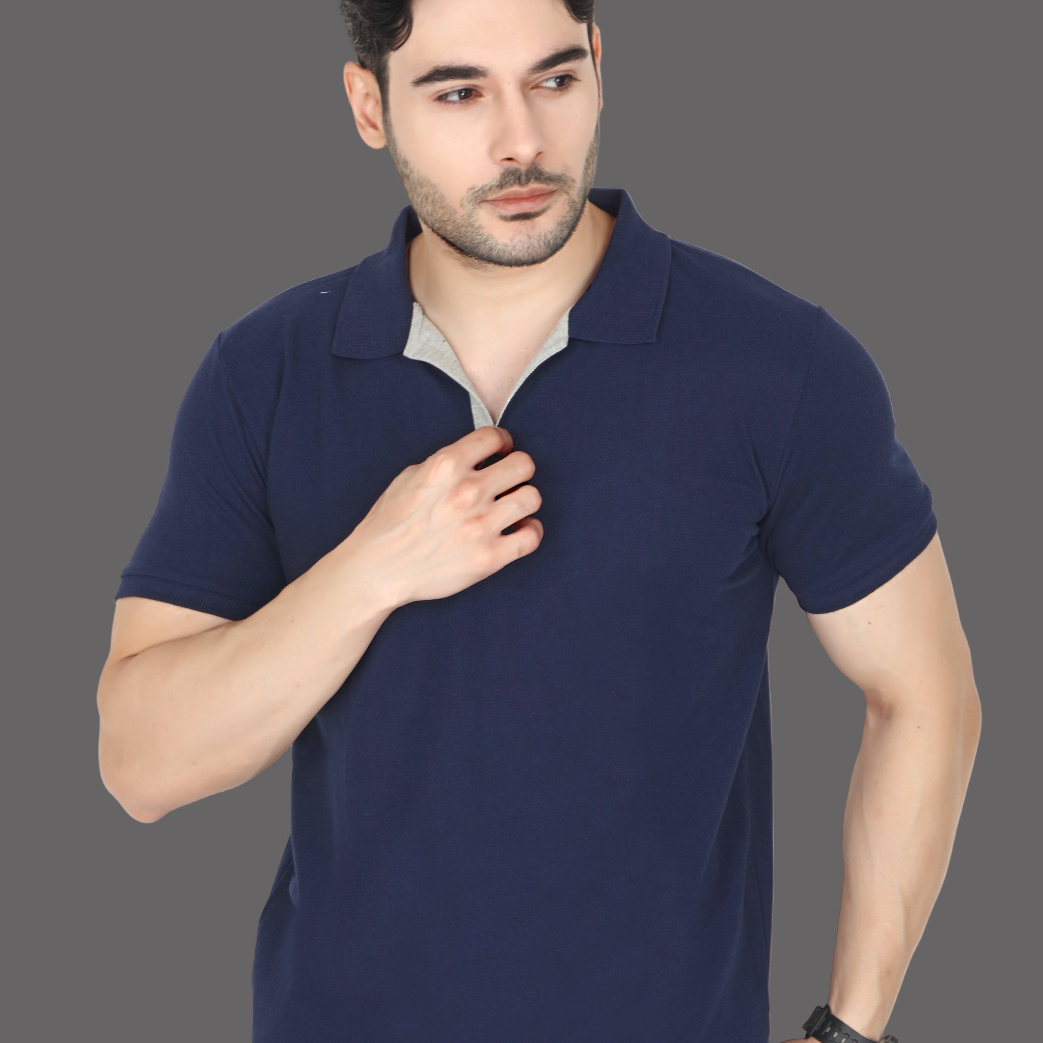 Man wearing a navy blue polo shirt on a white background