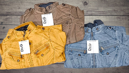 Three jackets in yellow, brown, and blue with D&G labels on a wooden surface.